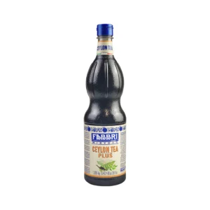 Tall dark glass bottle with a blue cap and a cream label showing blue CEYLON TEA text and decorative blue patterns nearby.