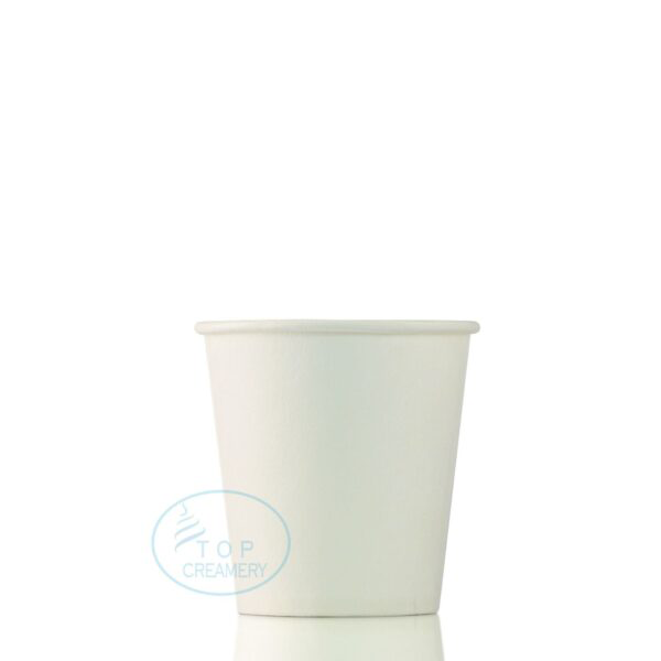 White disposable paper cup on a reflective surface with a faint blue Top Creamery watermark.