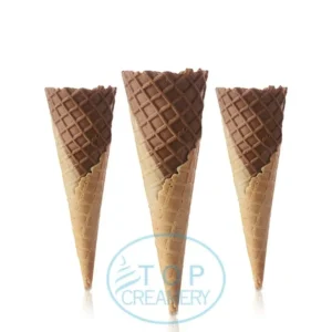 Three chocolate-dipped waffle cones standing upright in a row.