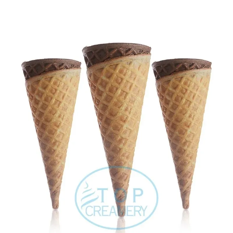 Three waffle cones with chocolate-dipped tops standing upright in a row on a white background, watermark visible at bottom edge.